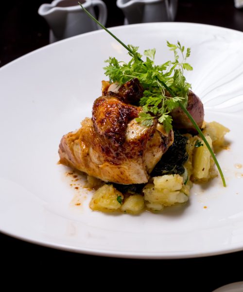 grilled chicken breast with potato greens spices sauces side view