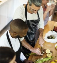 Group of friends cooking in the kitchen